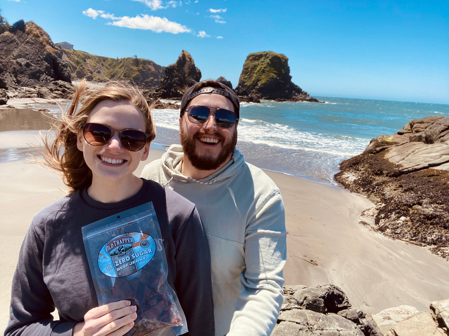 Couple with Old Trapper Beef Jerky at the beach