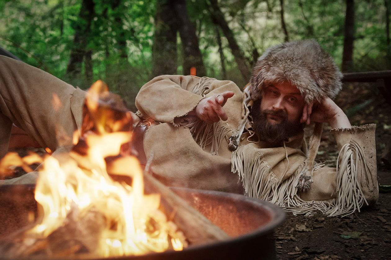 Old Trapper laying by the fire